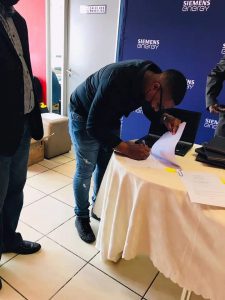 Alex FM Station Manager, signing a deal